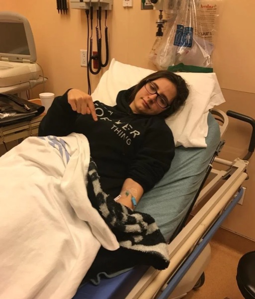 Brianna in a hospital bed during her illness journey